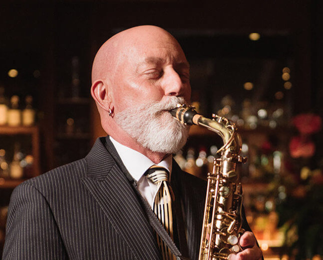 Rocky Holmes plays saxophone at Lewers Lounge